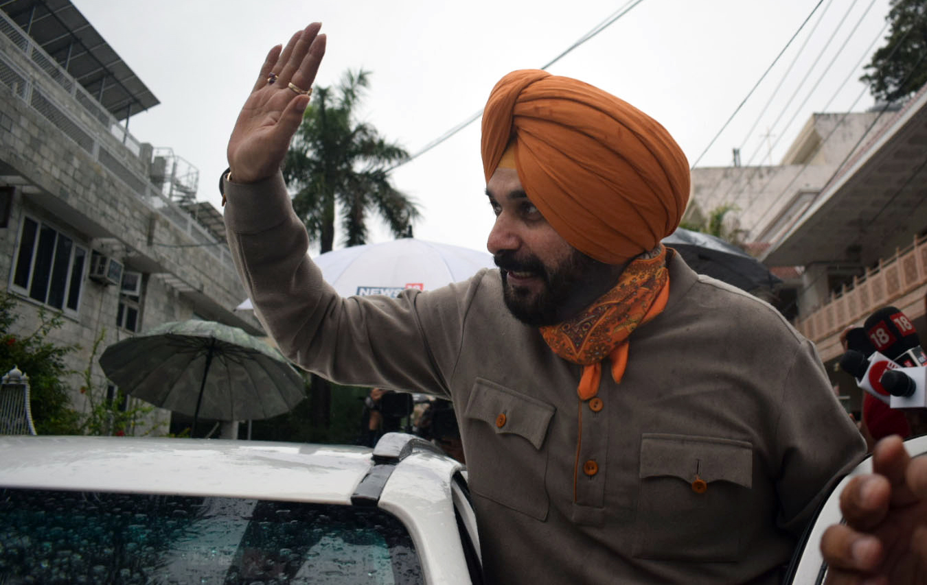 Newly-elected Punjab Congress President Navjot Singh Sidhu waves to supporters