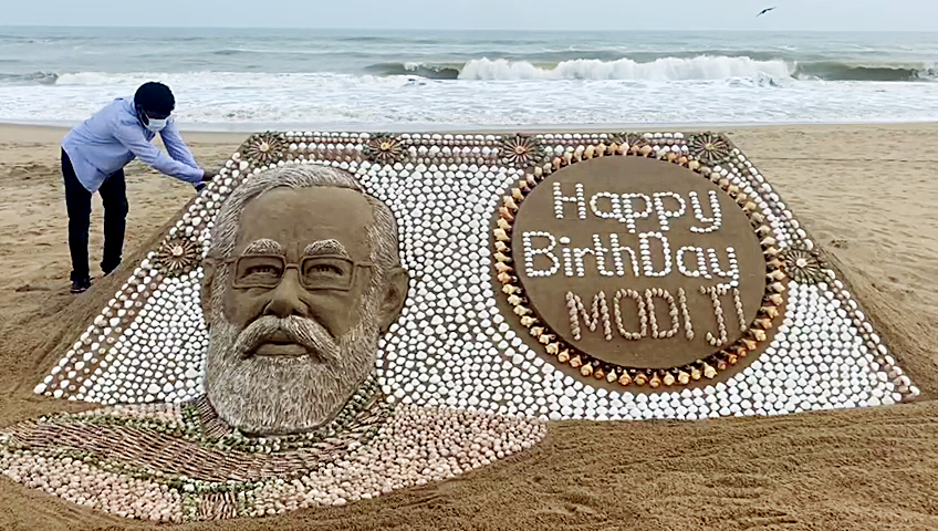 Sand artist Sudarsan Pattnaik extends his wishes by creating a sand sculpture of PM Narendra Modi