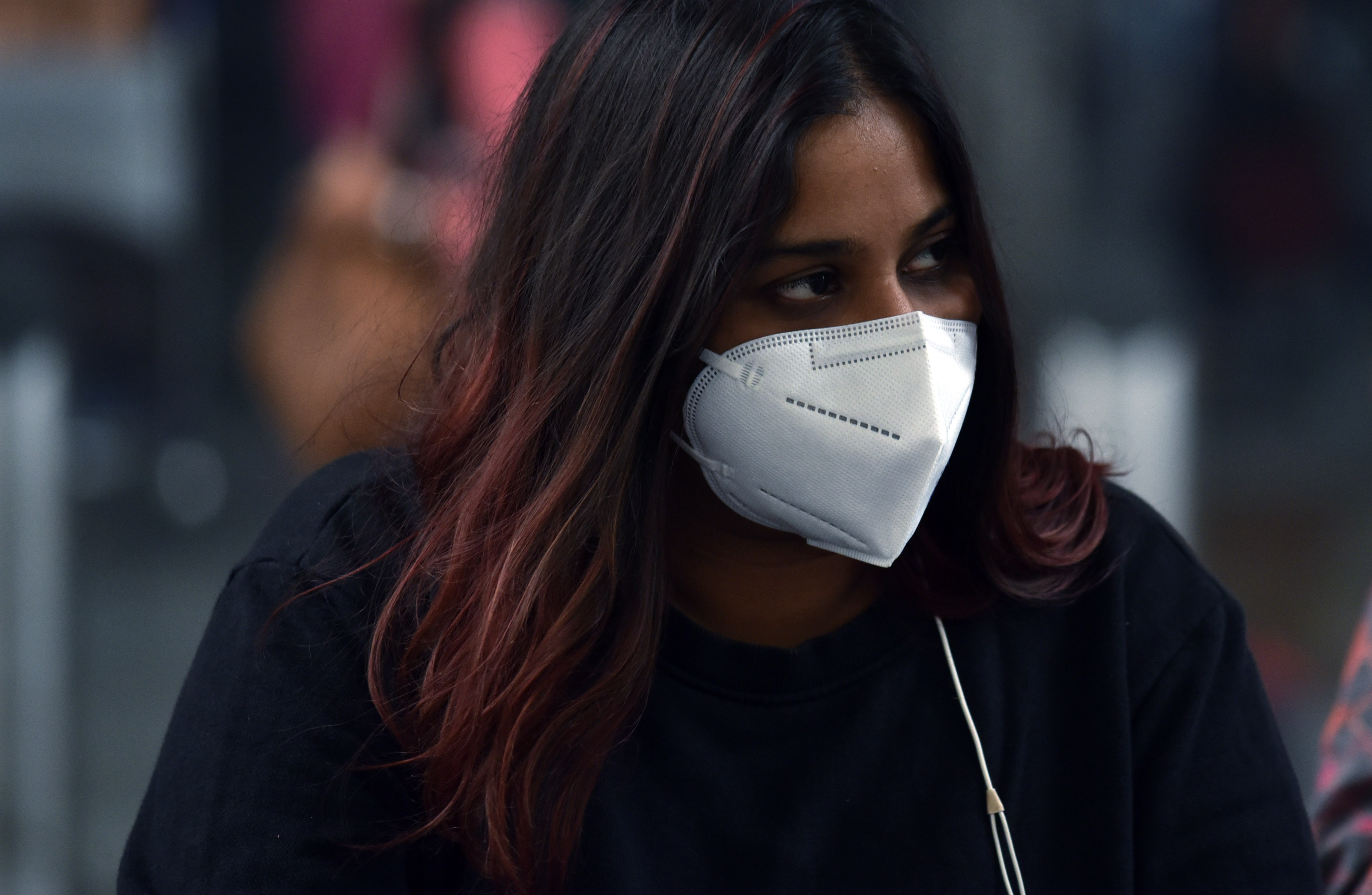 A girl wears a face mask to protect from air pollution